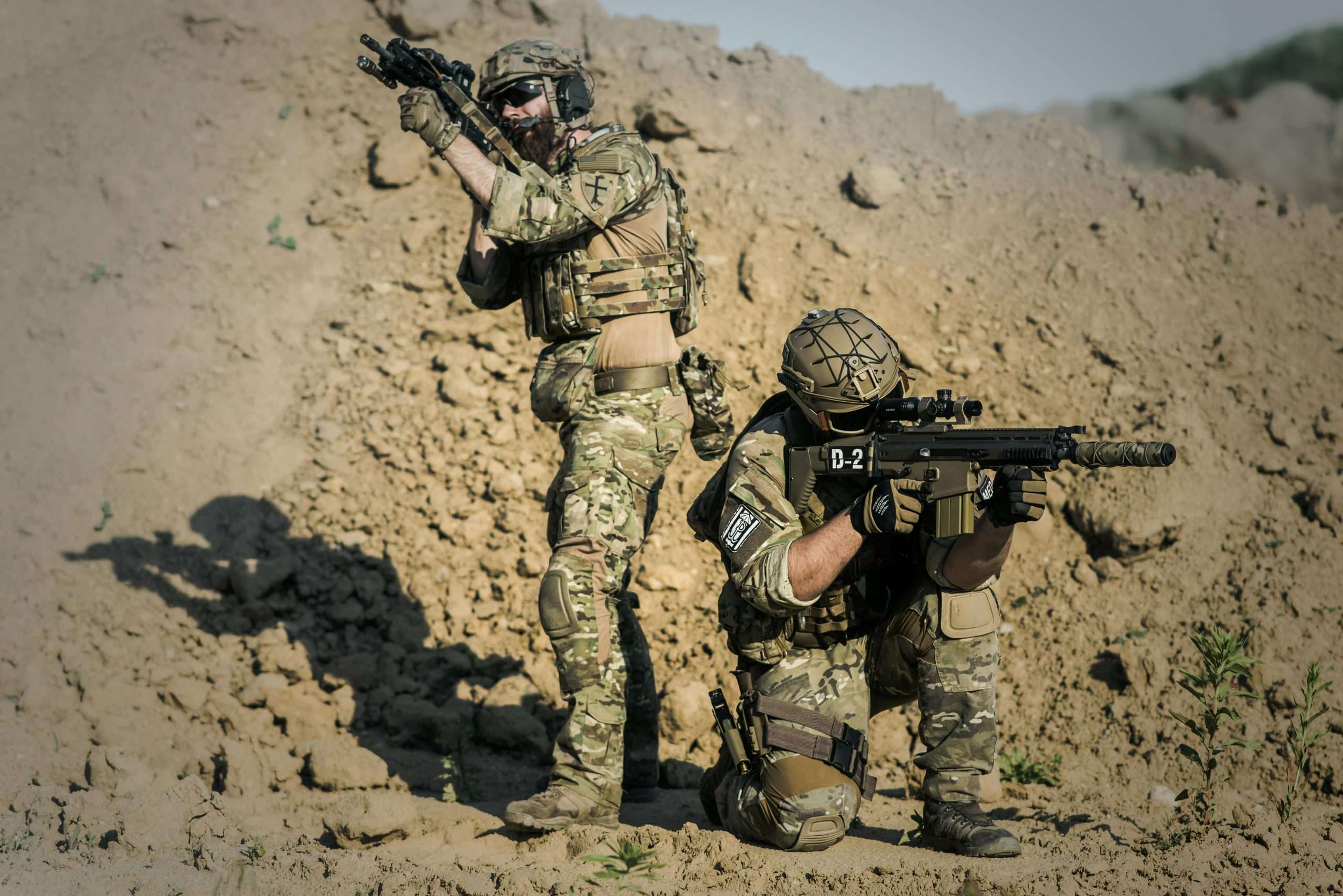 Two tactical operators in camouflage.