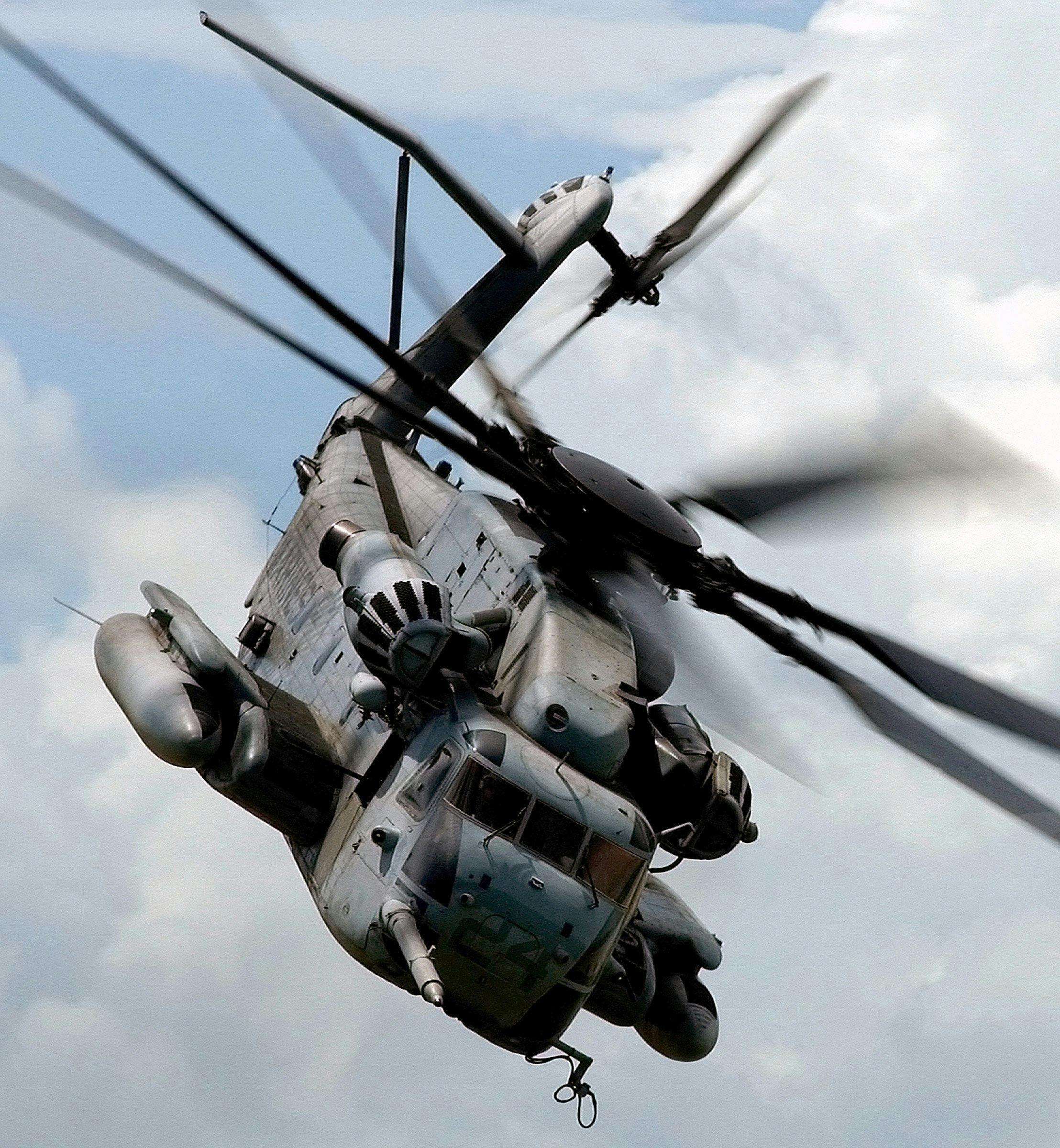 A large military helicopter flying in the sky.