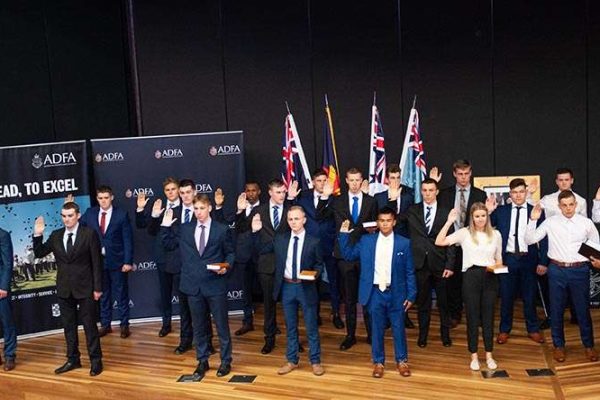 2021 ADFA Appointment Ceremony Group of recruits in formal attire taking an oath at a graduation ceremony.