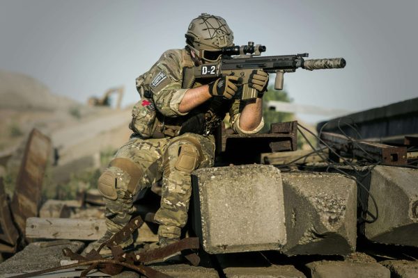 pexels-pixabay-163443 Soldier in camouflage holding a tactical rifle during defense training.