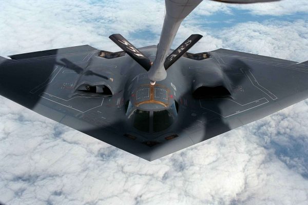 pexels-pixabay-87057 Stealth bomber receiving an in-flight refueling connection from a tanker aircraft above the clouds.